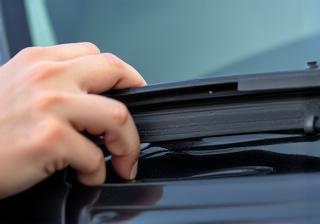 Inspecting a car's windshield wiper blade for wear
